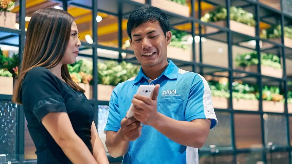 initial-colleague-image-technician-showing-customer-app-glo.webp