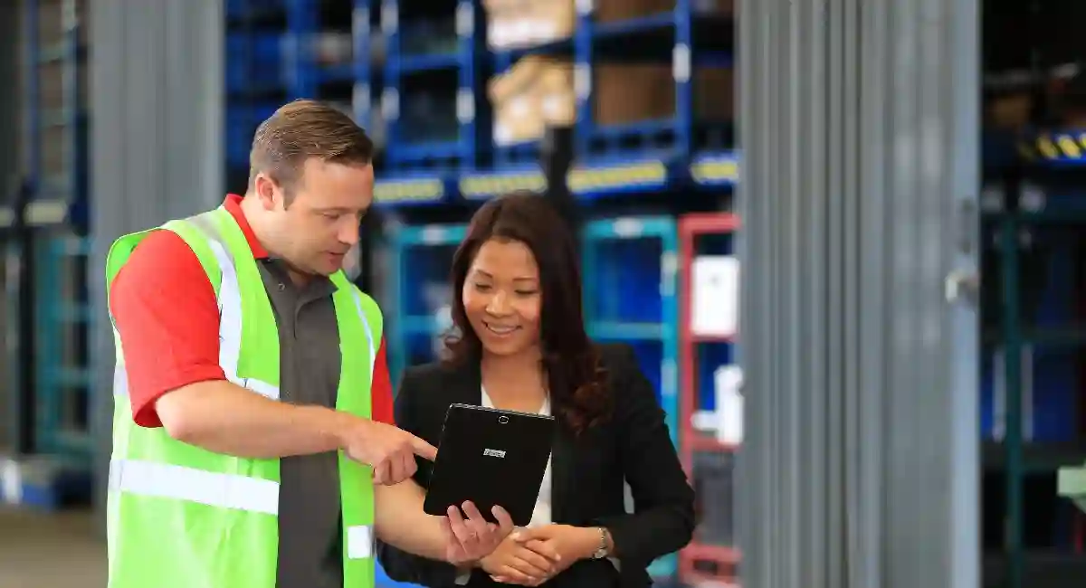 Rentokil technician with customer in a warehouse