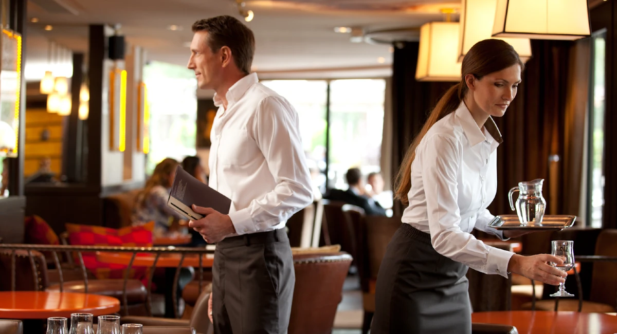 restaurant employee cleaning equipment or surfaces