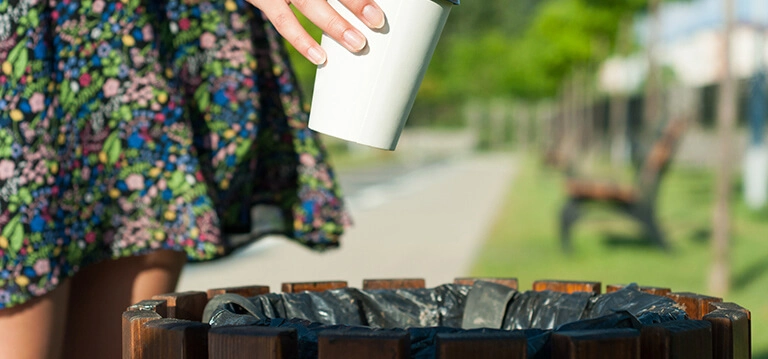 Person throwing rubbish in the bin